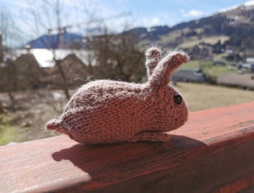Lapin au tricot devant les montagnes